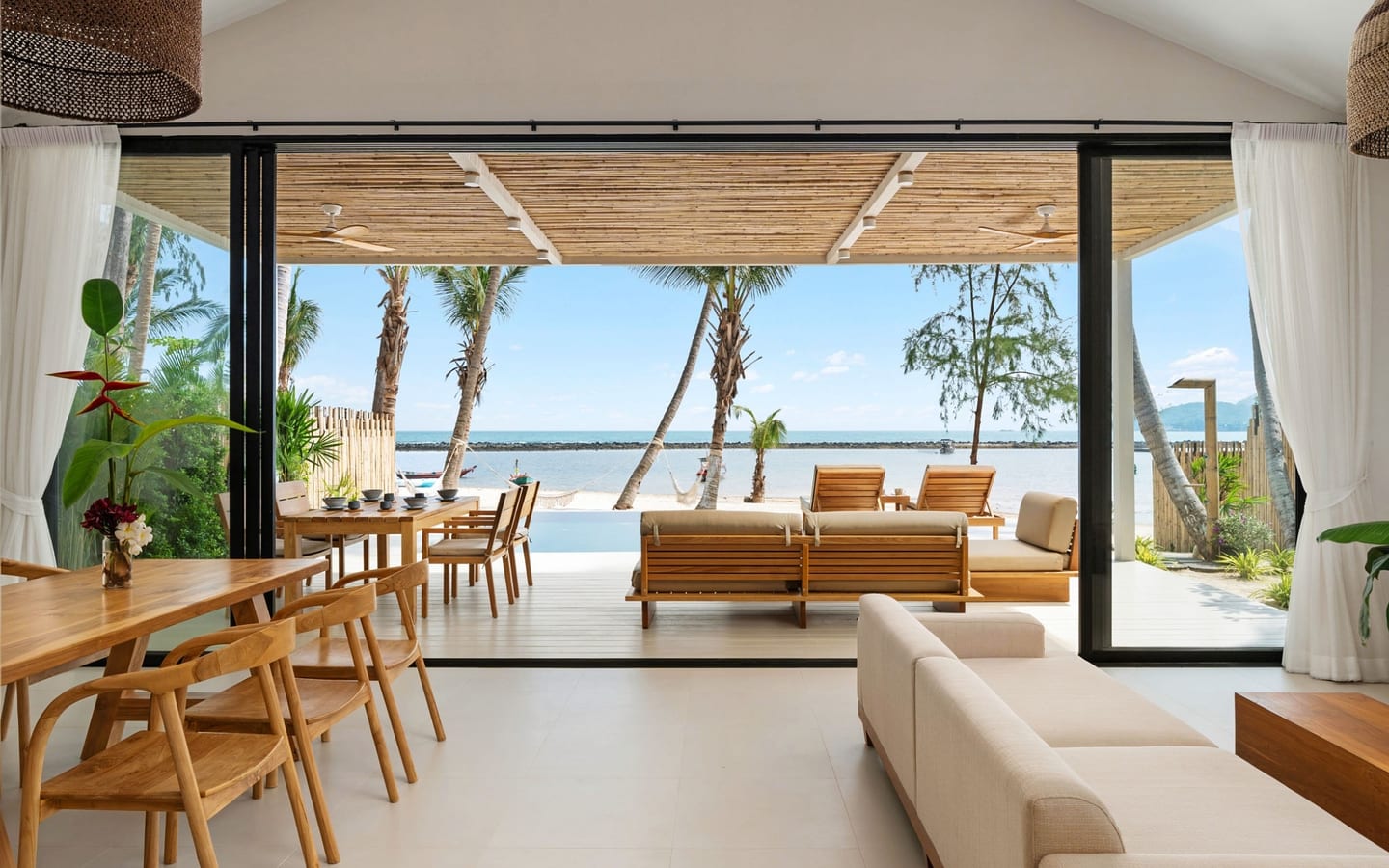 Luxury tropical resort pavilion framed by palms and water